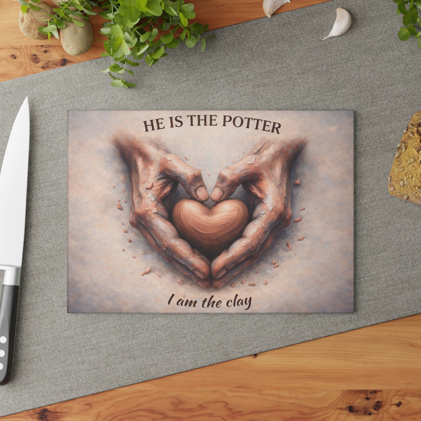 He Is the Potter, I Am the Clay Glass Cutting Board – Faith-Inspired Hands Forming Heart Design