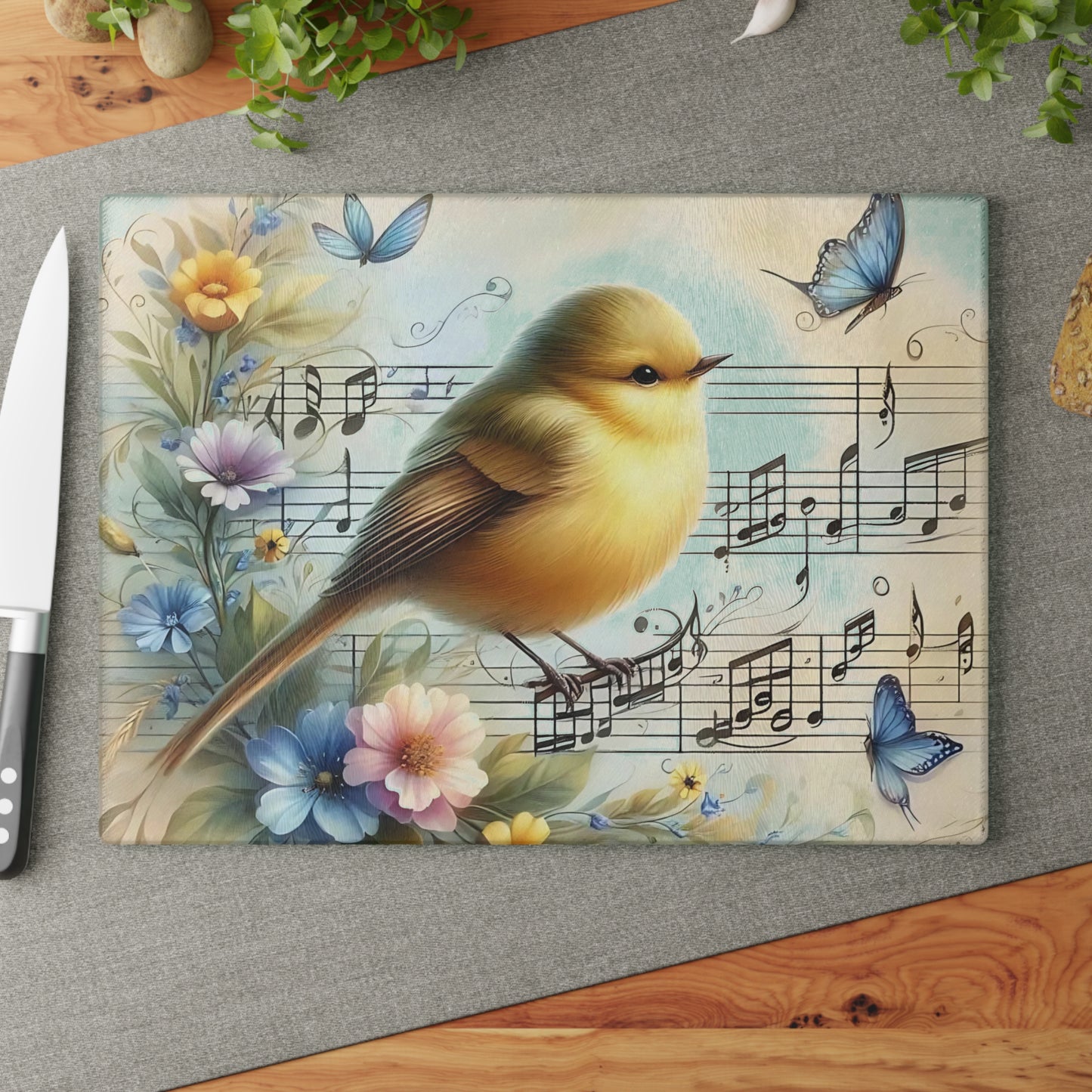 Tabla de cortar de vidrio templado con forma de pájaro rodeada de mariposas, flores y notas musicales.