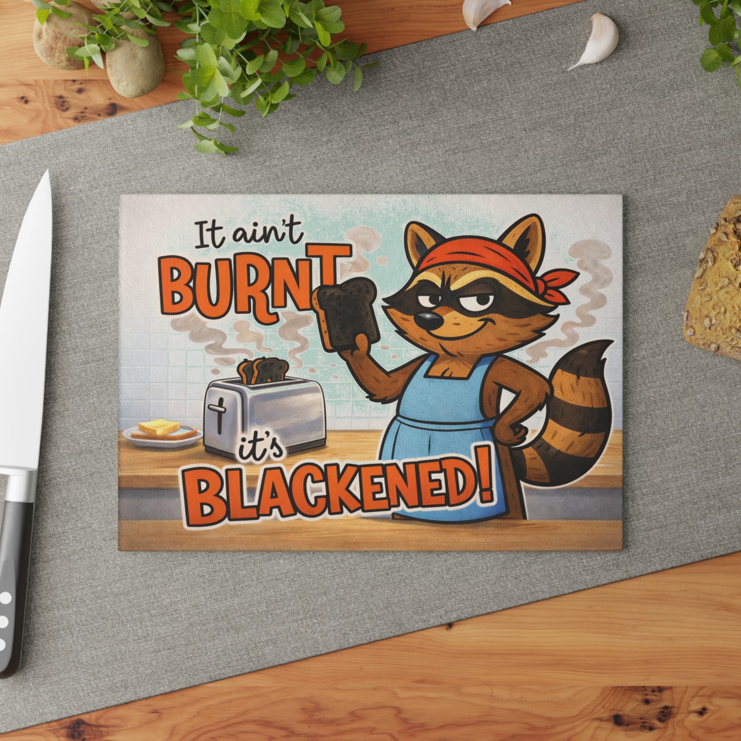 It Ain’t Burnt, It’s Blackened Glass Cutting Board – Sassy Raccoon Kitchen Art with Attitude