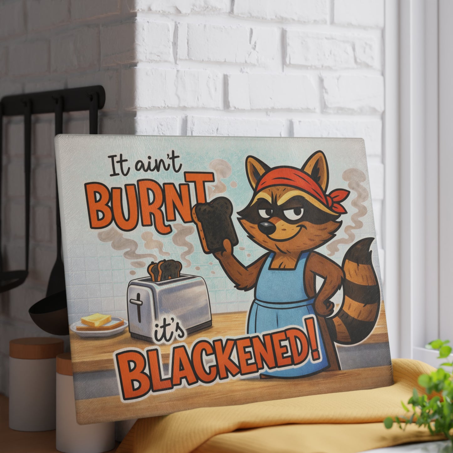 It Ain’t Burnt, It’s Blackened Glass Cutting Board – Sassy Raccoon Kitchen Art with Attitude