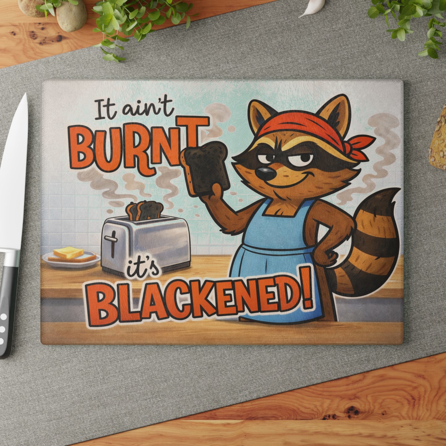 It Ain’t Burnt, It’s Blackened Glass Cutting Board – Sassy Raccoon Kitchen Art with Attitude