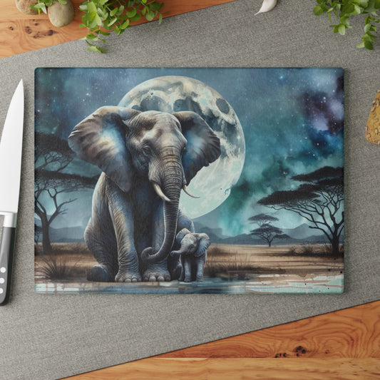 Tabla de cortar de vidrio con forma de mamá y bebé elefante, con una luna llena brillante detrás de ellos