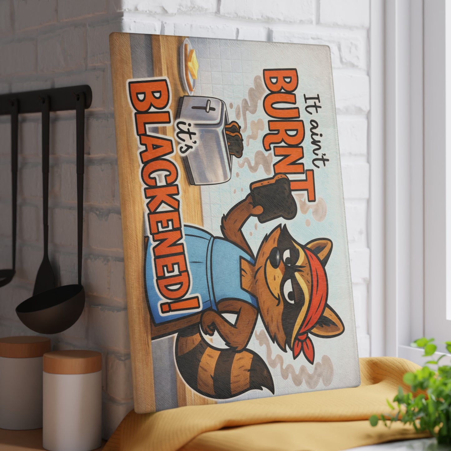 It Ain’t Burnt, It’s Blackened Glass Cutting Board – Sassy Raccoon Kitchen Art with Attitude